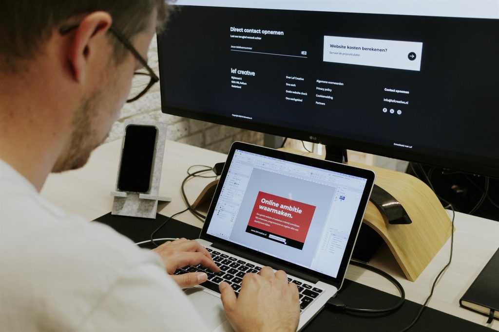 Lef Creative developer working on a website on a laptop and monitor